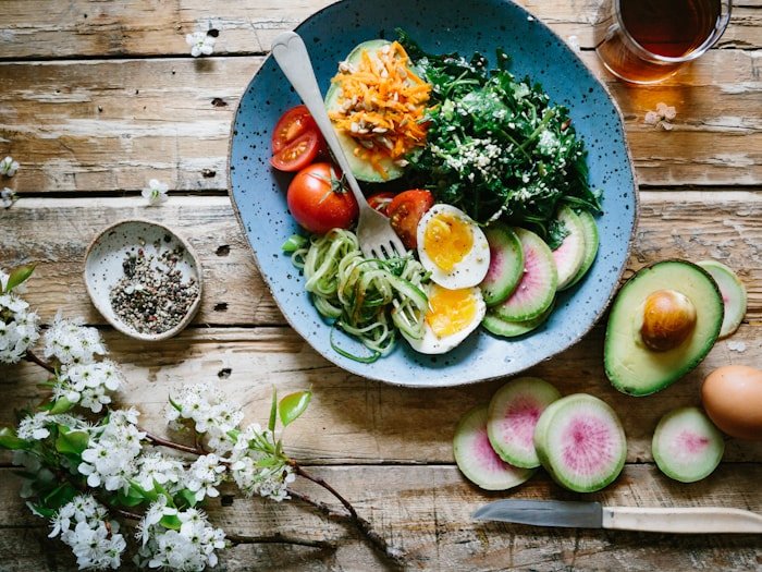 Colourful plate of greens, tomatoes, half-egg, and microgreens — initial nutrition assessment