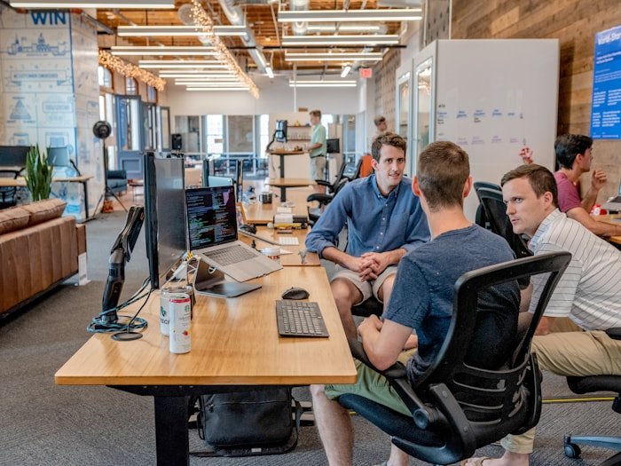 A team conferring in a modern workplace — corporate wellness and lunch-and-learn workshops