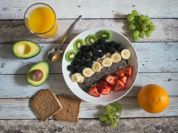 Breakfast grain bowl with chia, berries, kiwi, banana, and avocado — follow-up nutrition session
