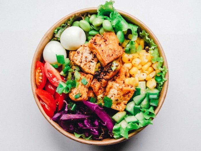 Protein-rich bowl with tofu, edamame, eggs, and corn — sustainable weight management