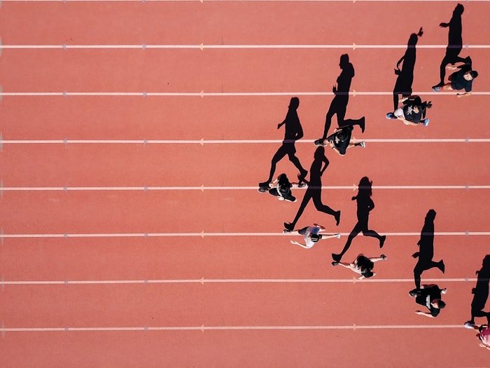 Runners on a track from above — sports and performance nutrition coaching